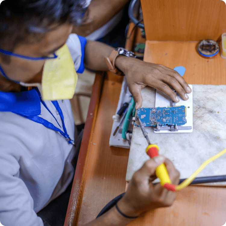 Electronics technician repairing a device